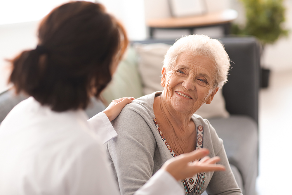 Elderly woman talking to a medical professional